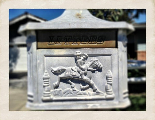 Decorative mailbox with a horseback rider and the word Letters, photographed by Melissa